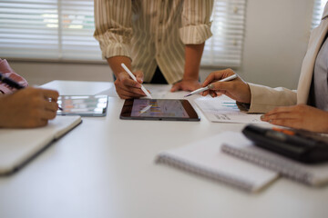 Marketing agency diverse workers analyzing research results, paper reports with diagrams on meeting table, discussing business startup creative strategy, planning finance, expenses, profit

