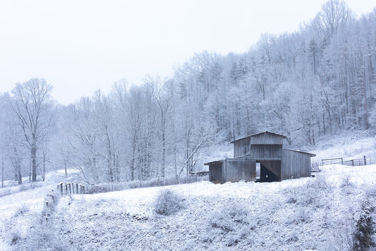 rustic barn in winter snow landscape