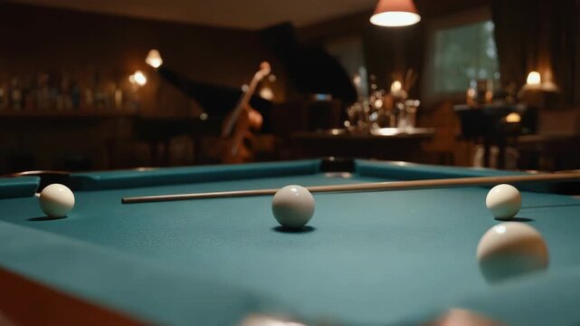 Close-up of billiard table with cue stick and balls in a dim room