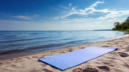 Outdoor Yoga Mat Positioned on Sandy Beach by Water Edge Under Open Sky in Bright Daylight With Soft Clouds Visible