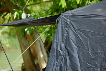 Close-up of Dark Camping Tent Awning with Guy Line Detail