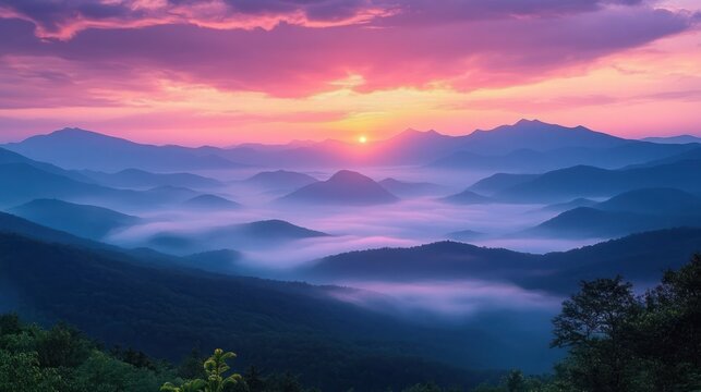 Sunrise over misty mountain ridges with vibrant purple, pink, and orange sky, layers of fog settling in forested valleys creating a serene and peaceful atmosphere - Powered by Adobe