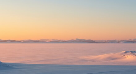 Obraz premium A serene winter landscape at sunrise. Soft colors paint a vast expanse of snow-covered land