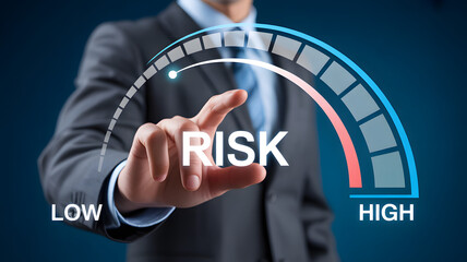 Businessperson pointing at digital risk gauge showing scale from low to high for risk assessment