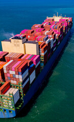 container ship, fully loaded with goods, sails out to sea, delivering products to various locations