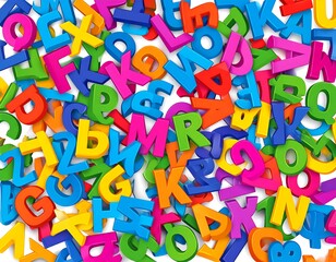 Colorful jumble of 3D alphabet letters scattered on a white surface