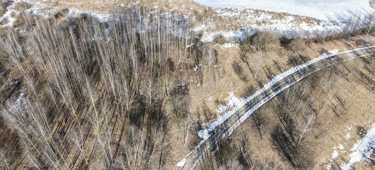 empty bike lane on riverbank in park at early spring. panoramic aerial view on sunny day.