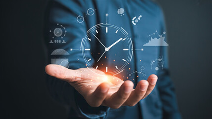 Businessman holding a holographic clock with digital icons floating around