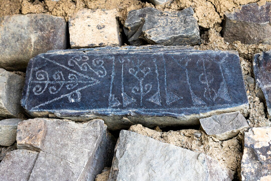 Old inscription on a stone embedded in a wall, Xinaliq, Azerbaijan