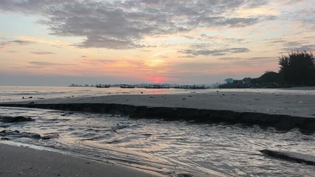 The atmosphere of Tuban beach, East Java, Indonesia in the morning, with calm sea waves