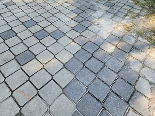Patterned Cobblestone Pavement With Dark Gray Blocks and Subtle Weathered Texture in Outdoor Path