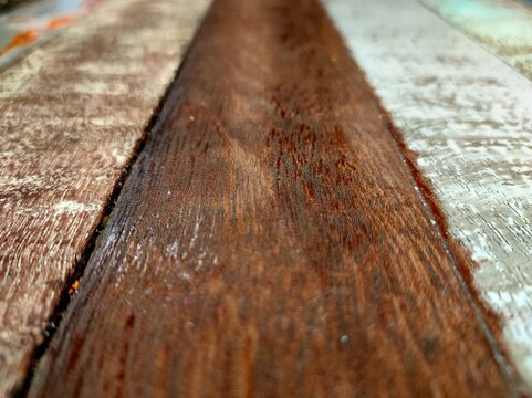 Wooden texture with different color tone in parallel or straight line.