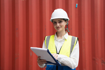 Cargo container and Import, export , African American worker inspecting and control of cargo container. Female worker working and managing container at container yard
