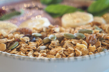 Granola bowl with fruits and nuts on a wooden table