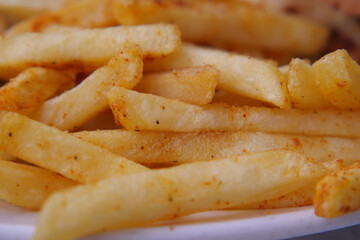 Crispy fries served on a plate with seasoning