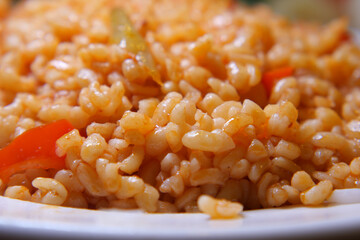 Delicious dish of rice with vegetables on a plate