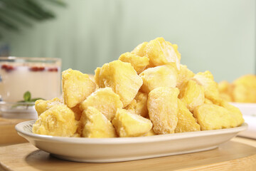 Crispy Golden Fried Potato Wedges on White Plate - Popular Snack Food