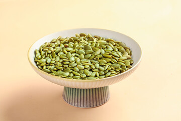 Roasted Green Pumpkin Seeds in White Bowl on Studio Background