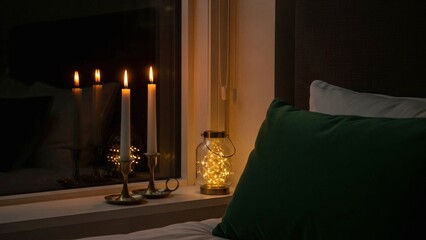 Warm Glow: Candles and Fairy Lights Illuminate a Cozy Bedroom Sc