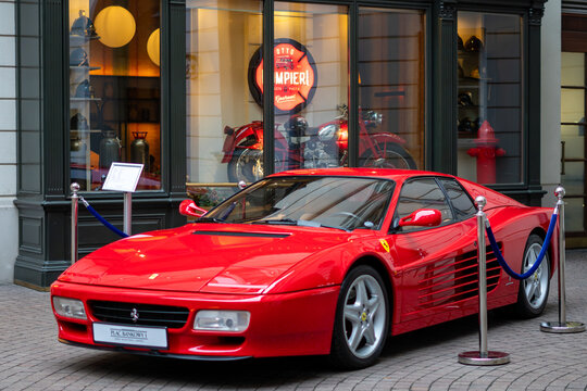 Ferrari Testarossa displayed at Plac Bankowy in Warsaw near elegant storefront and historic urban architecture