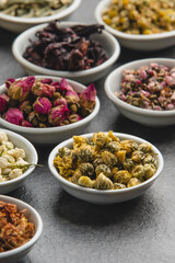 Assortment of Dried Herbs and Flowers in Small White Bowls.
