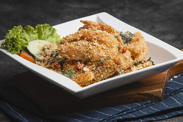 Crispy Fried Chicken with Herbs and Spices on a White Plate.
