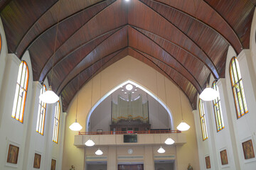 church interior with wooden roof and lamp decoration