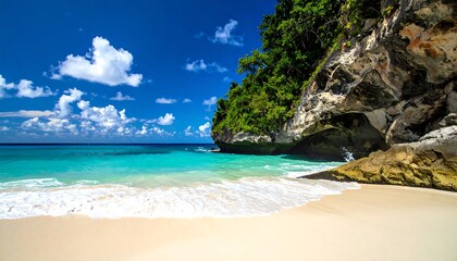 Fototapeta premium Turquoise ocean meets sandy shore by a verdant cliff under a bright blue sky