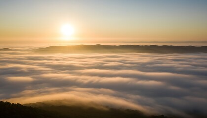 Fototapeta premium sunrise above clouds over mountain landscape for travel inspiration and nature background use