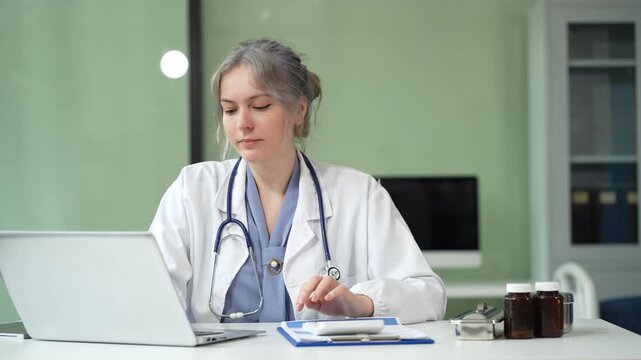 Doctor woman use a service fee calculator to save money on health insurance, drug cost concept.