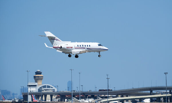 Charter Hawker 900XP approaching Dallas Fort Worth International Airport (DFW), blue skies.