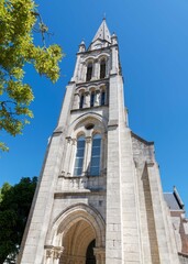 Romanesque church of Saint-Gaudens of Fouras in Charente-Maritime. Fa&ccedil;ade with a arch porch and romanesque-inspired bell tower surmounted by a spire framed by four pinnacles