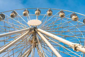 Part of a Ferris wheel in contrast with the blue sky shortly before the fair starts.