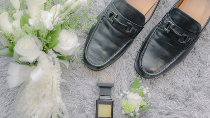 grooms shoes with hand bouquet decoration