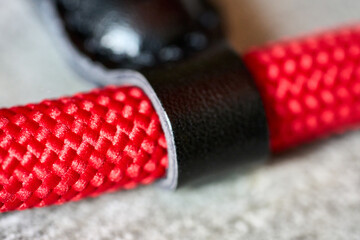 Close up of red rope with a black strap