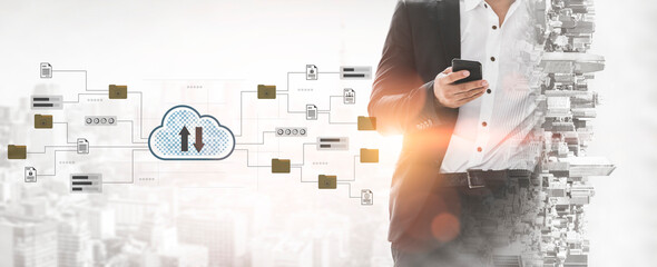 A businessman stands with a smartphone against a city backdrop, showcasing cloud technology themes that signify digital transformation and data management solutions. Gantry