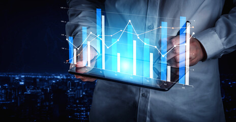 A professional interacts with a digital tablet displaying vibrant data visualizations, including graphs and statistics, set against a captivating night cityscape. Scalp