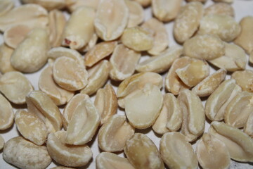 Dry roasted peanuts spread out on a flat surface in a bright, well-lit kitchen setting during the day
