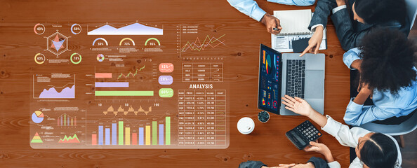 Professionals engage in a collaborative meeting, focusing on data analysis and insights. The scene features digital graphs and charts, promoting effective decision-making. Trope