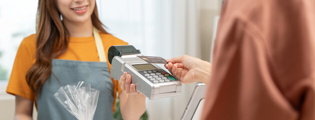 Cashless payment in shopping concept, Close-up hands using credit card pay at cafe.