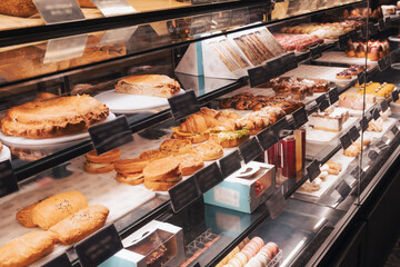 Bakery cafe showcase with a variety of pastries, cakes, sandwiches and desserts. Modern interior...