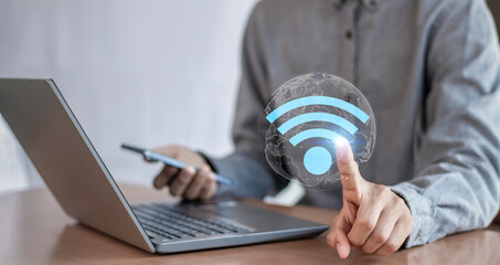 Business communication social network concept.Businessman using laptop with wifi icon.