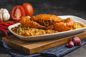 Delicious Chili Crab with Noodles on a White Plate.