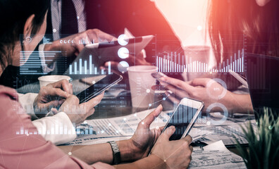 Diverse professionals concentrate on digital devices during a collaborative meeting, showcasing data visualization and analytics in a dynamic workplace. Scalp