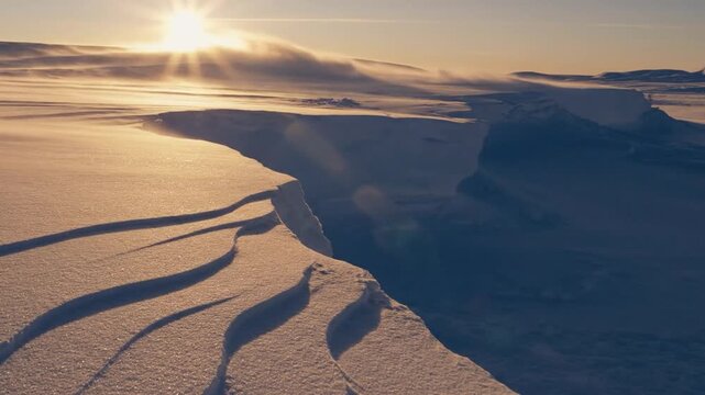 Snowy landscape with wind and sun in the background