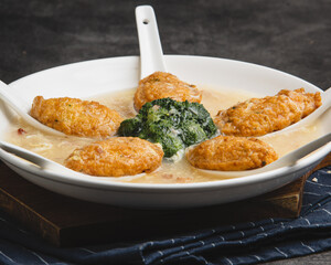 Delicious Fried Fish Cakes with Creamy Sauce and Spinach.