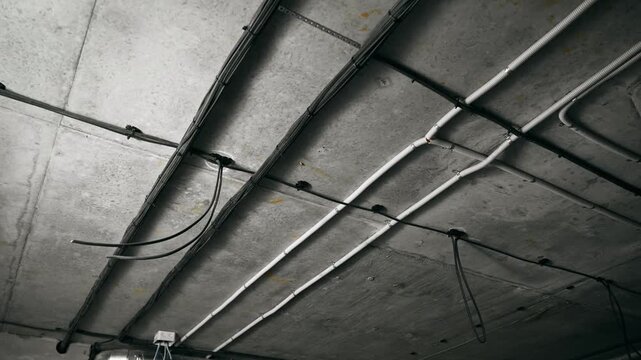 Exposed Pipes And Wiring Overhead, Structural Infrastructure With Raw Textures And Overhead Cabling