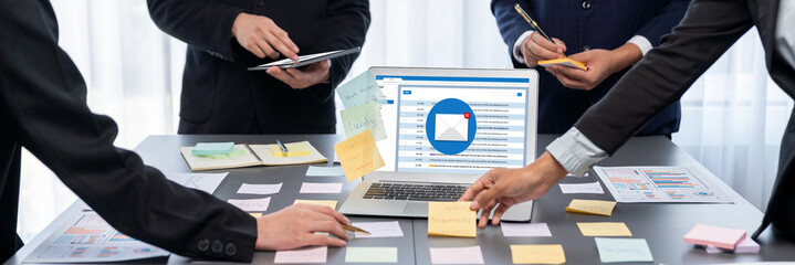 Analyst team use sticky note for creative and analytic brainstorm for business idea with BI data dashboard on laptop screen. Analysis financial data visualization tech for marketing strategy. Prodigy