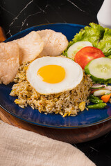 Delicious Fried Rice with Fried Egg and Side Salad.