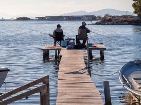 Tourlida, Greece. October 27, 2025: Fishermen and fishing boats in the fishing village Tourlida, Mesolongi in Greece